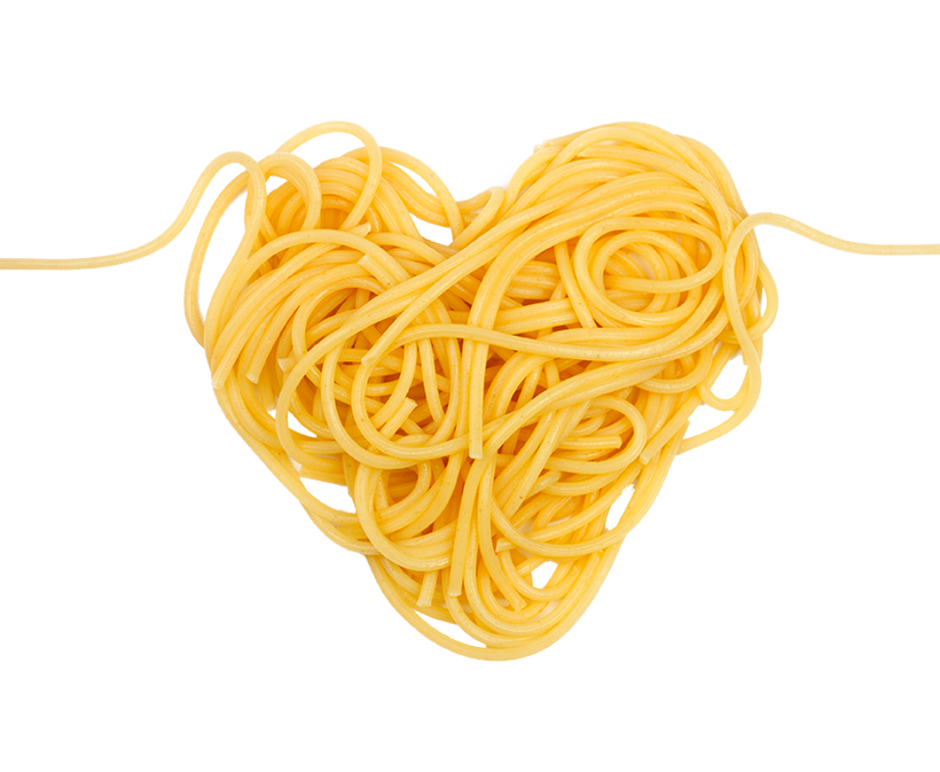 Heart shape formed by uncooked yellow spaghetti noodles on black background