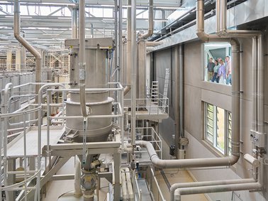 Complex network of industrial pipes and metal structures inside a factory or processing plant