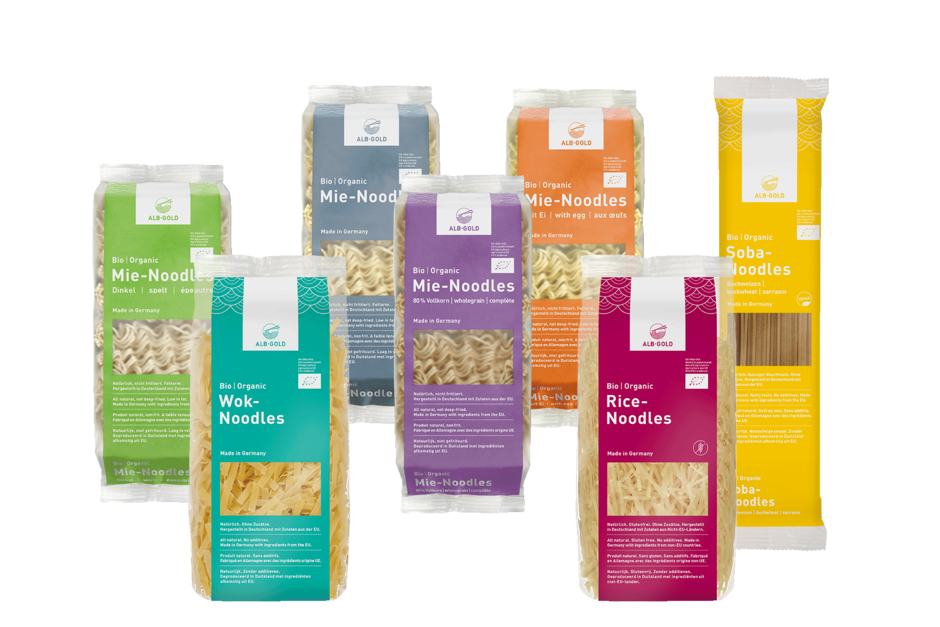 Seven colorful packages of assorted nuts and dried fruits, each labeled with different flavors and ingredients