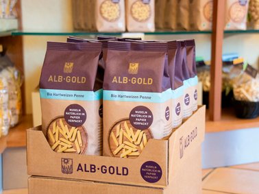 ALB-GOLD paper packaging for pasta displayed on a store shelf with other pasta products in the background